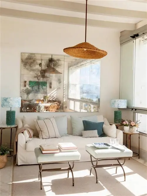 Гостиная с белым диваном и состаренным зеркалом.