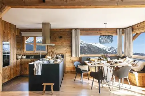 Современная деревенская кухня открыта для столовой с видом.