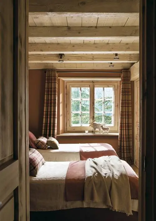 Детская спальня с двумя кроватями и клетчатыми шторами.