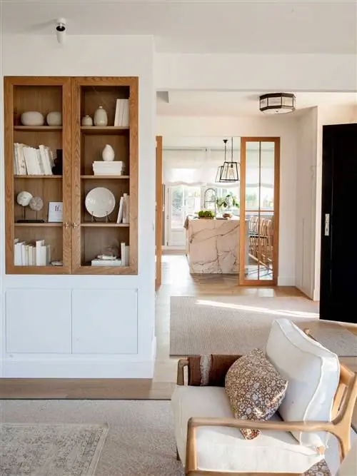 Гостиная с белым и деревянным шкафом.