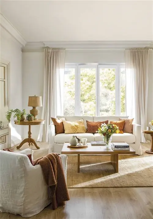 Белый диван с подушками цвета меди и экрю