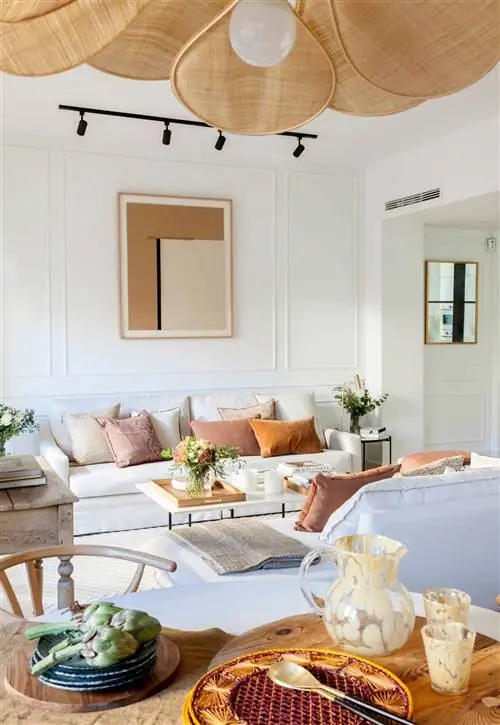 Гостиная с раскладывающимися диванами и столовая с деревянной мебелью.