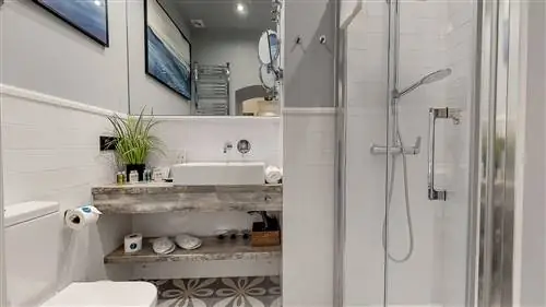 ванная комната с серыми стенами, облицованными белой плиткой, и плавающей раковиной