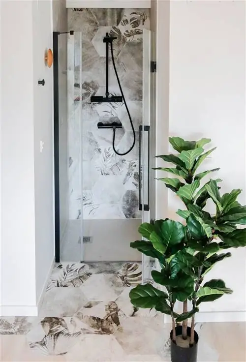 душевая кабина с цветочной плиткой и матовым черным смесителем