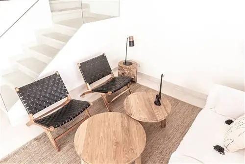 деревянные и плетеные кожаные кресла, деревянные журнальные столики и ковер из волокна