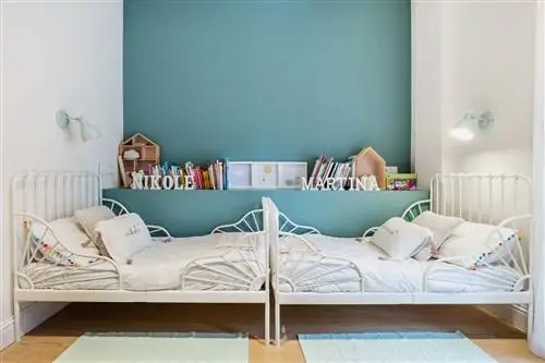 детская комната с двумя белыми коваными кроватями