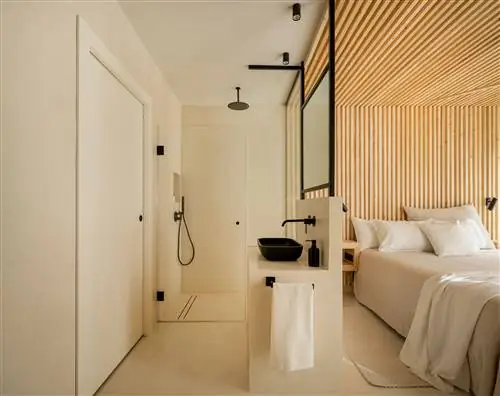 спальня с ванной комнатой и деревянным потолком и облицовкой стен