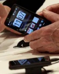 Посетитель осматривает смартфон HTC на стенде Vodafone на выставке технологий CeBIT 3 марта 2010 года в Ганновере, Германия.