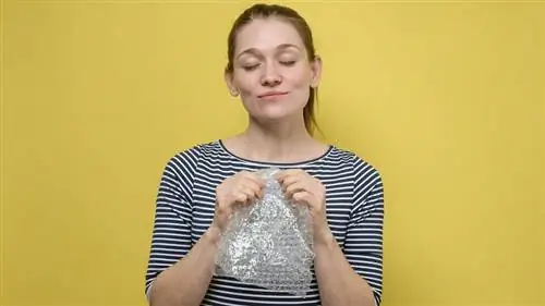 женщина лопает пузырчатую пленку