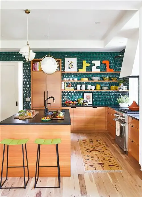 кухня с деревянными шкафами и темной кафельной стеной