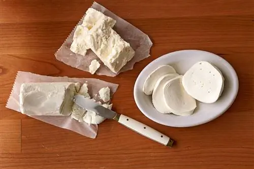 свежая фета, моцарелла и сыр шевре на деревянном столе