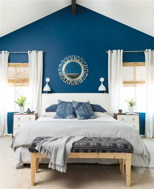 спальня с синей стеной и серым постельным бельем