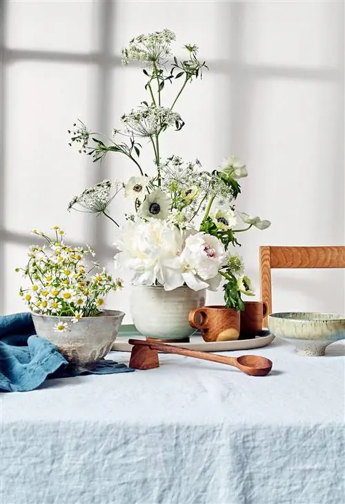 льняная скатерть с белыми цветами и керамикой