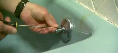 Выверните винты из накладки переливной планки слива.