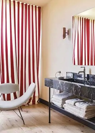 В ванной мраморная мебель Marquina и шведские бра 40-х годов, кресло Reversivel от Карло Хаунера и Мартина Эйслера