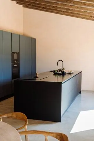 Тон песчаника с Майорки преобладает с черными штрихами, такими как кухонный остров и дизайнер Эмили…