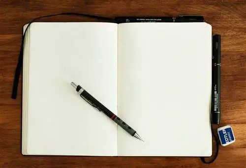 открытый блокнот, механический карандаш и ластик