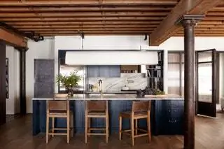 Кухня с большим мраморным островом, голубыми шкафами и табуретами Restoration Hardware была совершенно…
